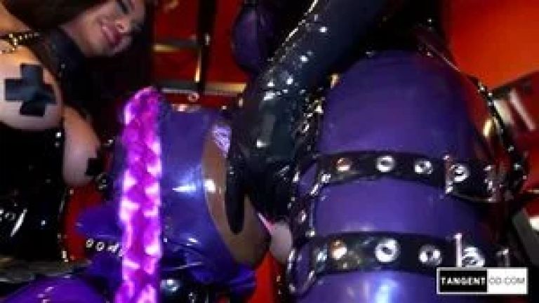 TANGENTOD Two Women in Black Latex Dominate Bound Submissive in Purple Catsuit