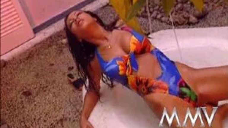 Hot brunette posing wet outdoors